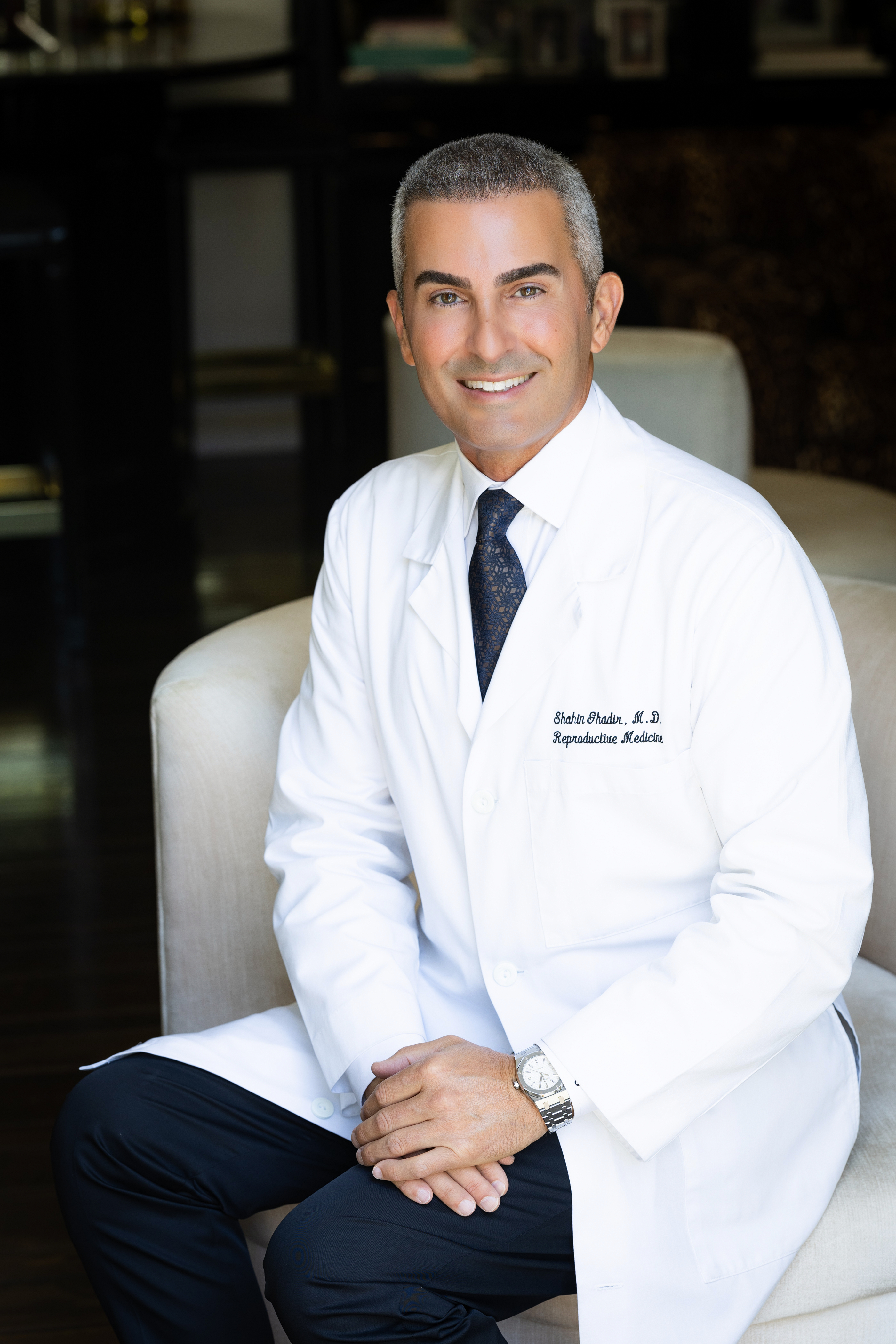 Dr. Shahin Ghadir in a white lab coat embroidered with his name and specialty