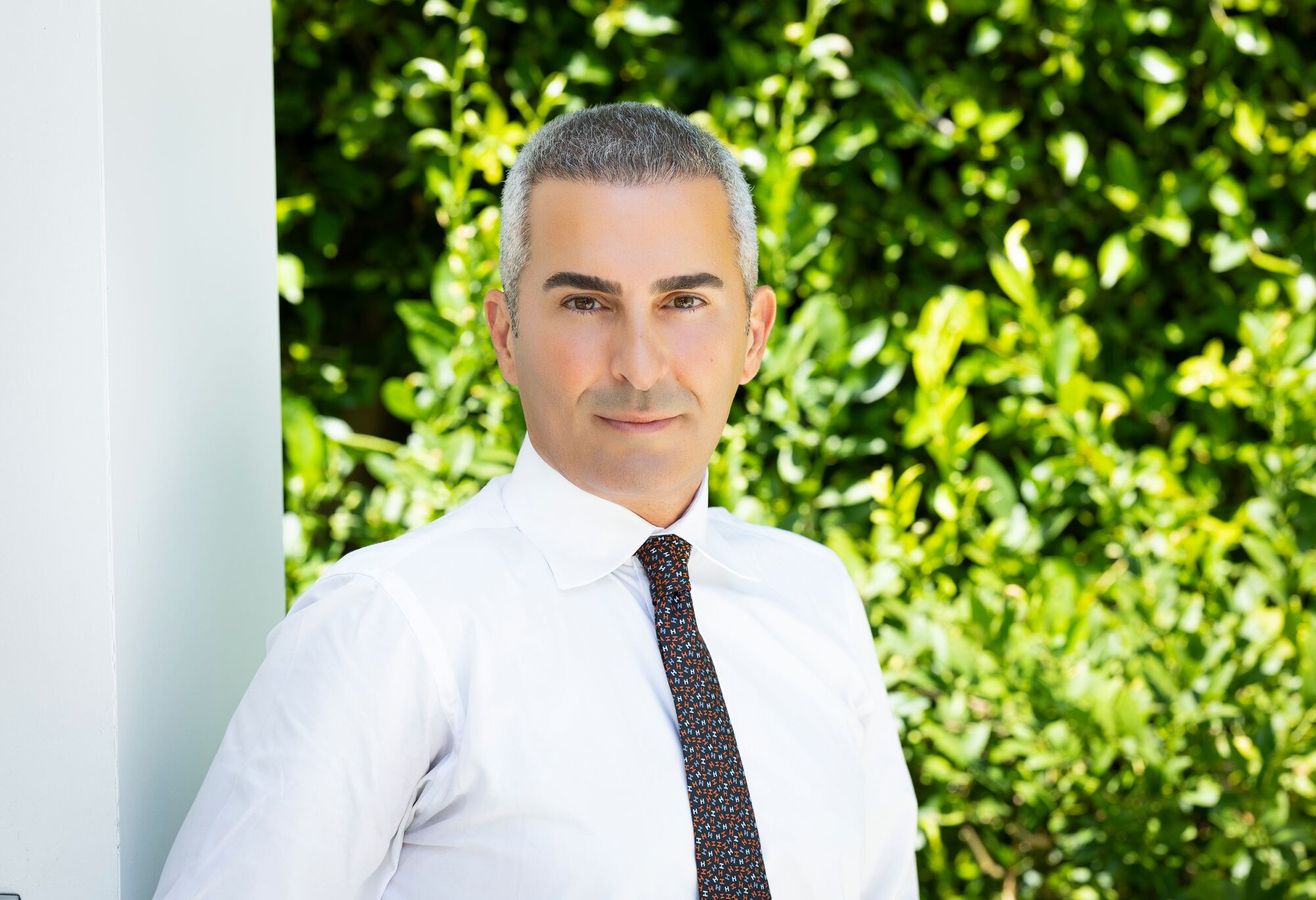 Dr. Shahin Ghadir in a sunlit garden setting